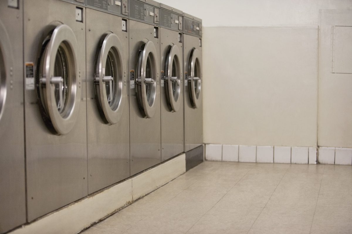 Row of self-service clothes dryers in laundromat